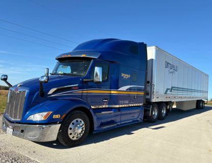 A Ditzfeld Transfer semi truck and trailer parked outside on a sunny day
