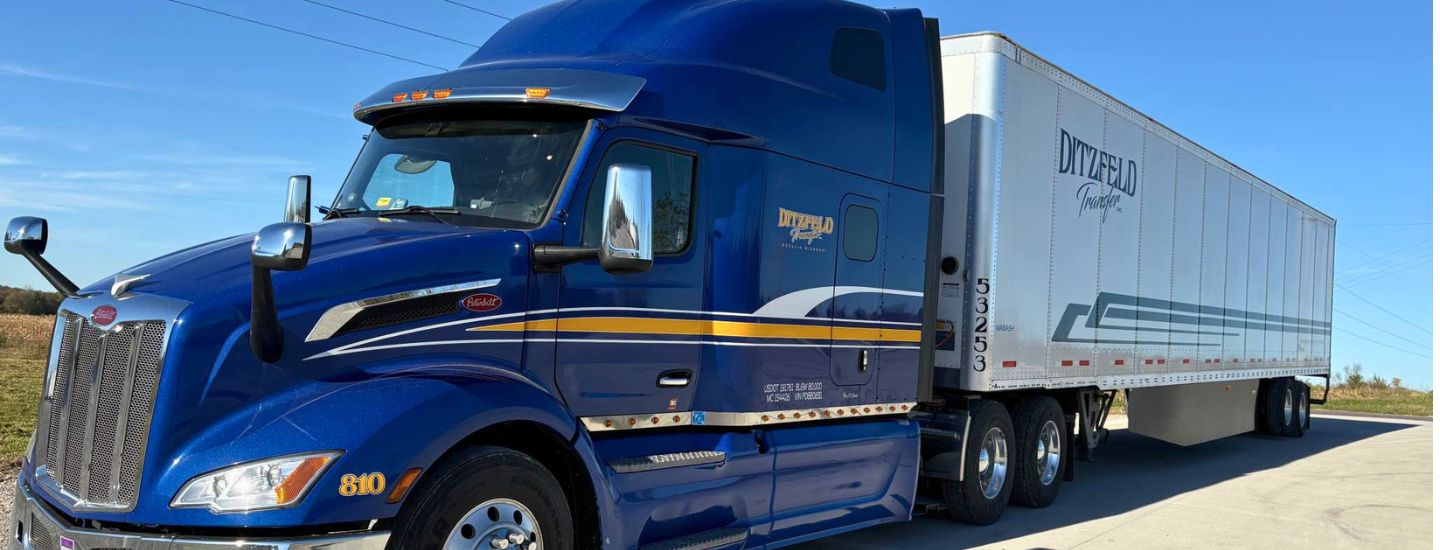 A Ditzfeld Transfer semi truck and trailer parked outside on a sunny day